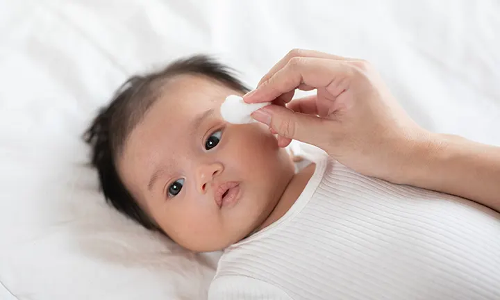 Cleaning baby’s face eyes ears nose