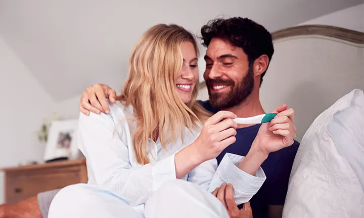 Woman holding a pregnancy test